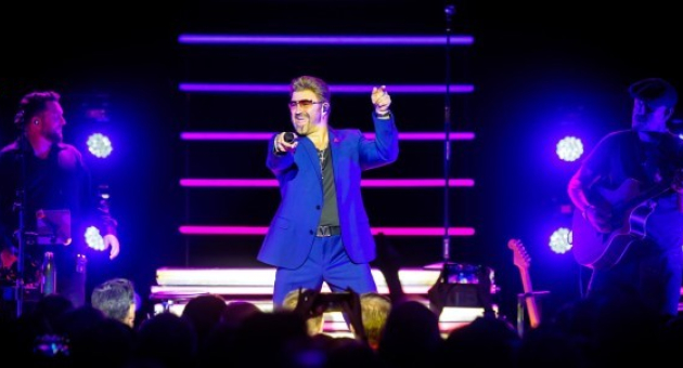 Rob Lamberti als George Michael op podium met blauwe verlichting en uitzinnig publiek