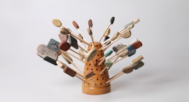 Houten sculptuur met stokjes en gevonden objecten
