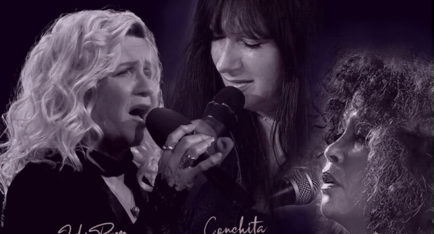 Drie zangeressen zingen elk in microfoon op podium