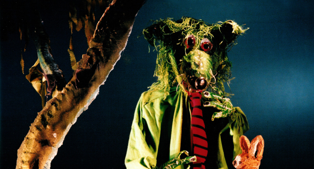 Groene popwolf met stropdas en klein konijntje