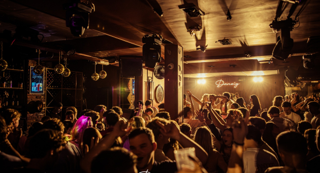 Crowded club with people dancing and partying