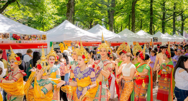 Group of dancers in traditional attire at a festival.