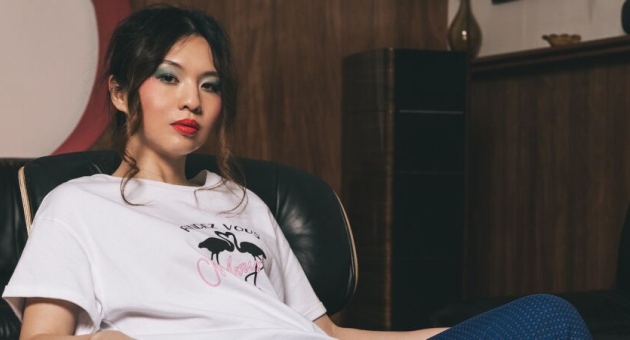 Young woman in a T-shirt sitting on a couch