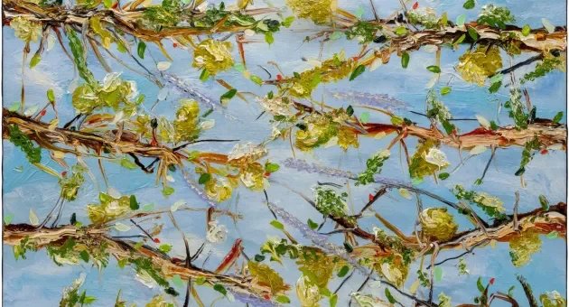 Frisse groene bloesems en takken tegen een blauwe lucht