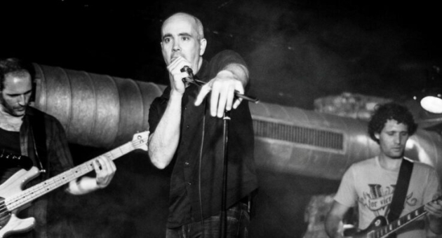 Muzikanten op het podium. Drie muzikanten spelen in een donkere omgeving.