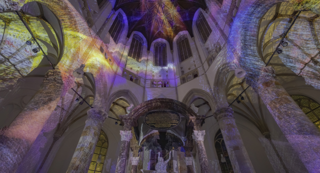 Art installation in historical setting. Interior of a church with colorful light projections