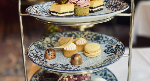 Een tiered serveerschaal met verschillende soorten gebak en desserts.