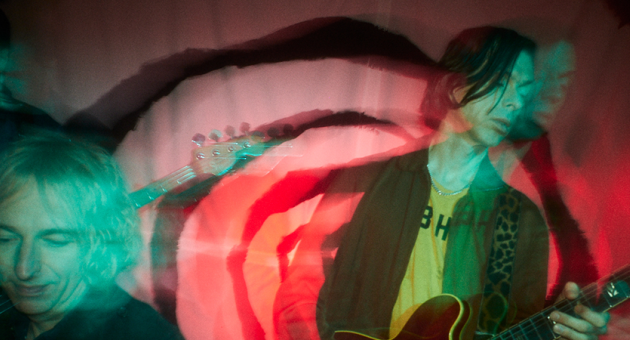 Little Barrie performing live on stage, guitarist Barrie Cadogan in the foreground