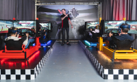 Vier deelnemers in een race simulator starten een race