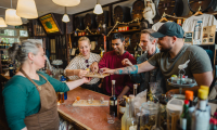 Five people enjoying drinks in a bar.