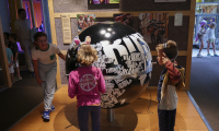 Children listening to music from the globe