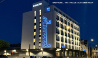 Modern hotel with blue lighting at night.
