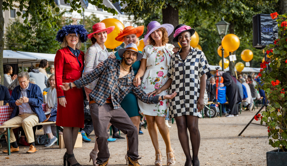 Groepsfoto van mensen in feestelijke kleding en hoedjes