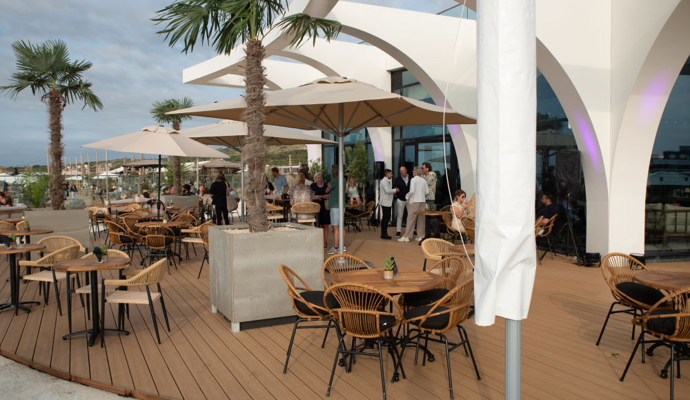 Terras van EVE met palmbomen en gezellige drukte