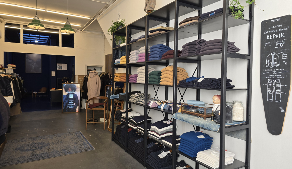 A store with shelves full of clothing and accessories.