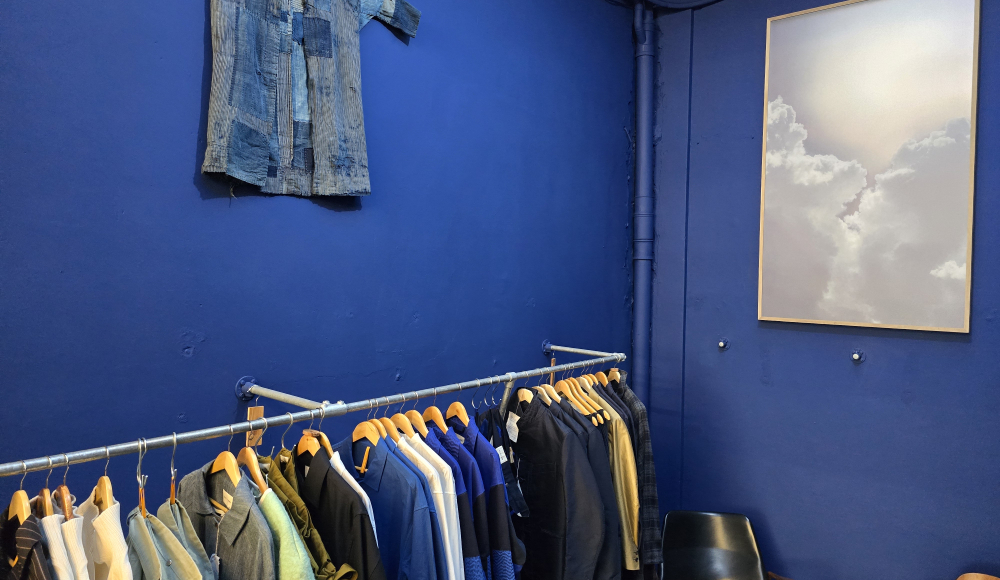 Blue room with rack of clothes