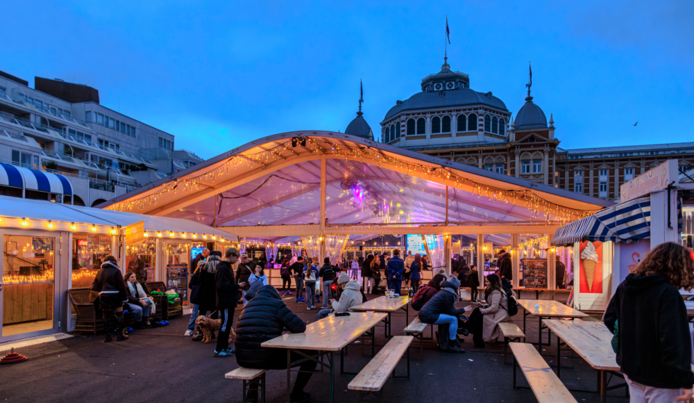 Cozy winter market with visitors and lights