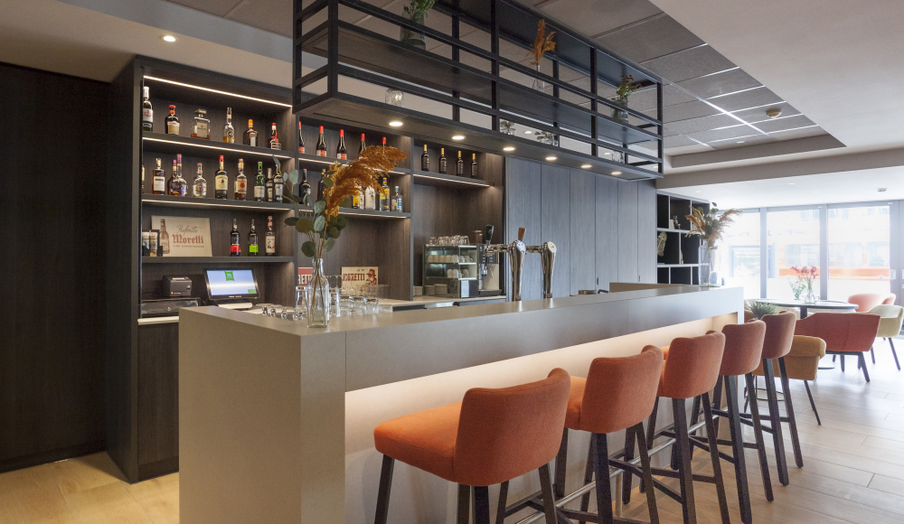 Lege hotelbar met hoge oranje stoelen ervoor