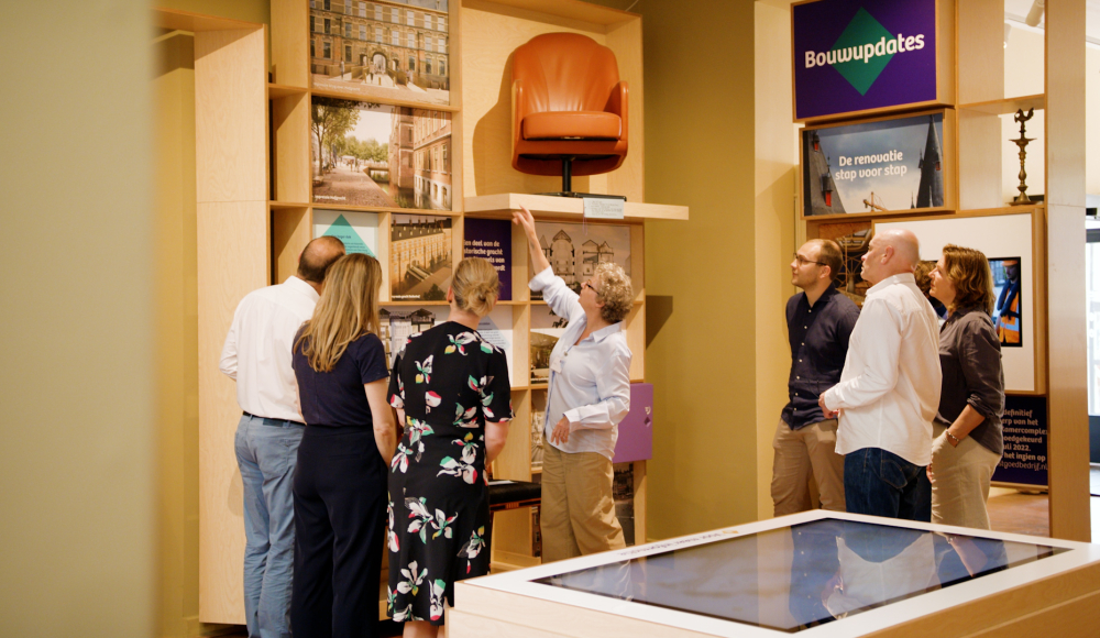 A group of people is looking at information about construction updates.