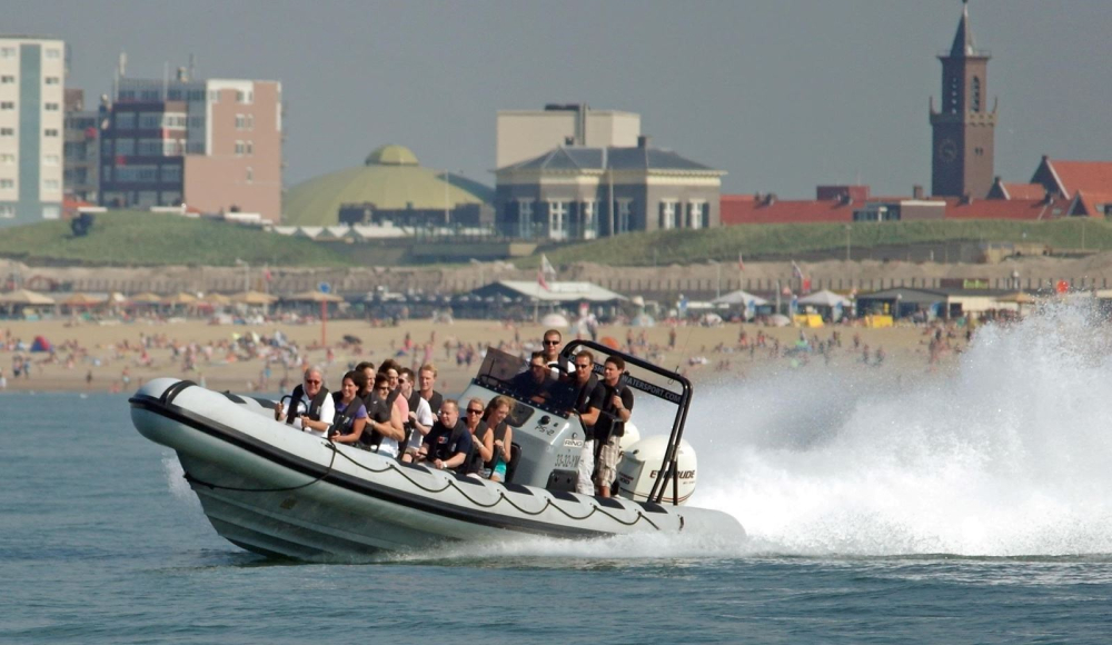 Snelle powerboaten gaan zo hard over het Scheveningse water gaan dat er witte opspattende golven ontstaan. 