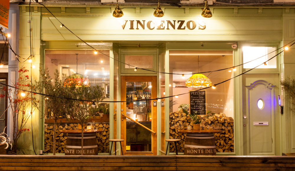 Cozy restaurant with green facade and lights