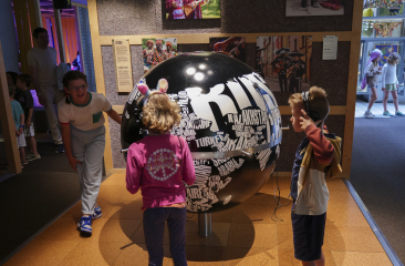 Children listening to music from the globe