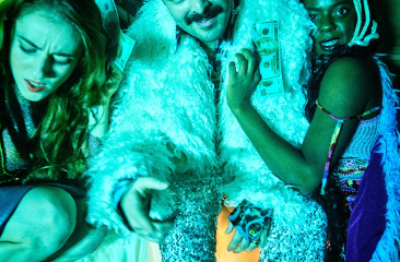 Three people in flamboyant clothing holding money.