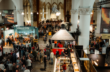 Beverage festival with crowd and booths in a large hall