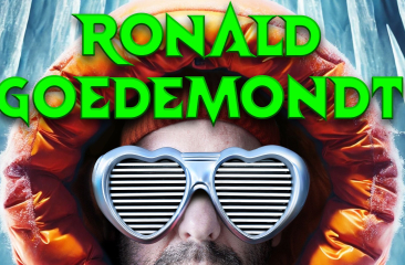 Close-up van Ronald Goedemondt met zilveren shutter-shades in de vorm van hartjes op. Hij draagt een oranje jas met de capuchon omhoog. Hij staat voor een zilveren achtergrond. In neon-groene letters is Ronald Goedemondt te lezen. 