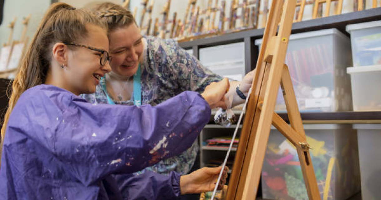 Child painting with museum guide Child painting with museum guide