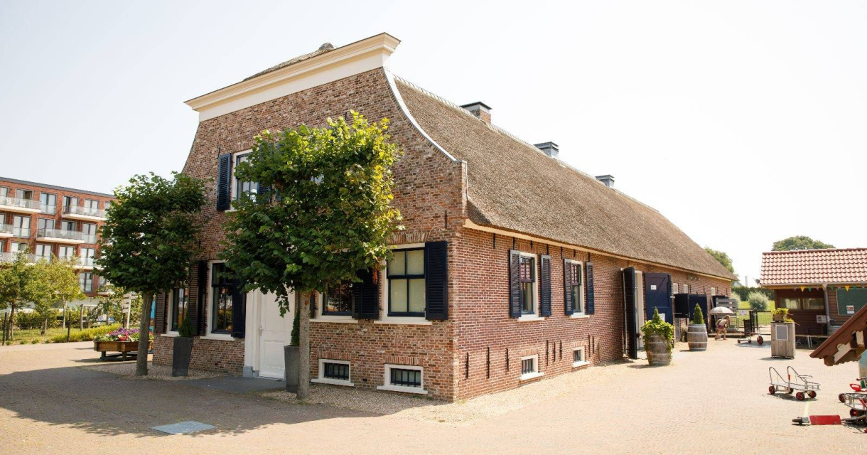 Traditional farm with thatched roof and trees Traditional farm with thatched roof and trees