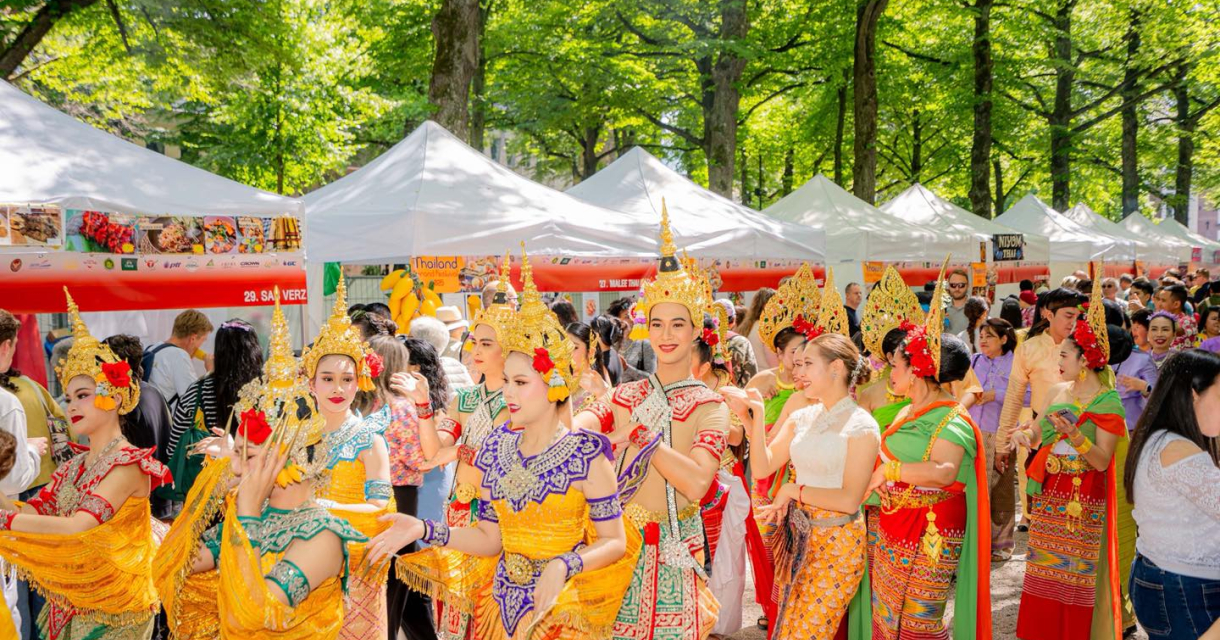 Group of dancers in traditional attire at a festival.