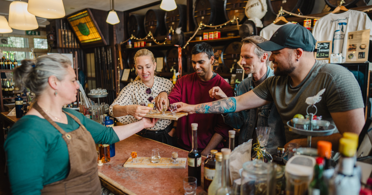 Five people enjoying drinks in a bar.