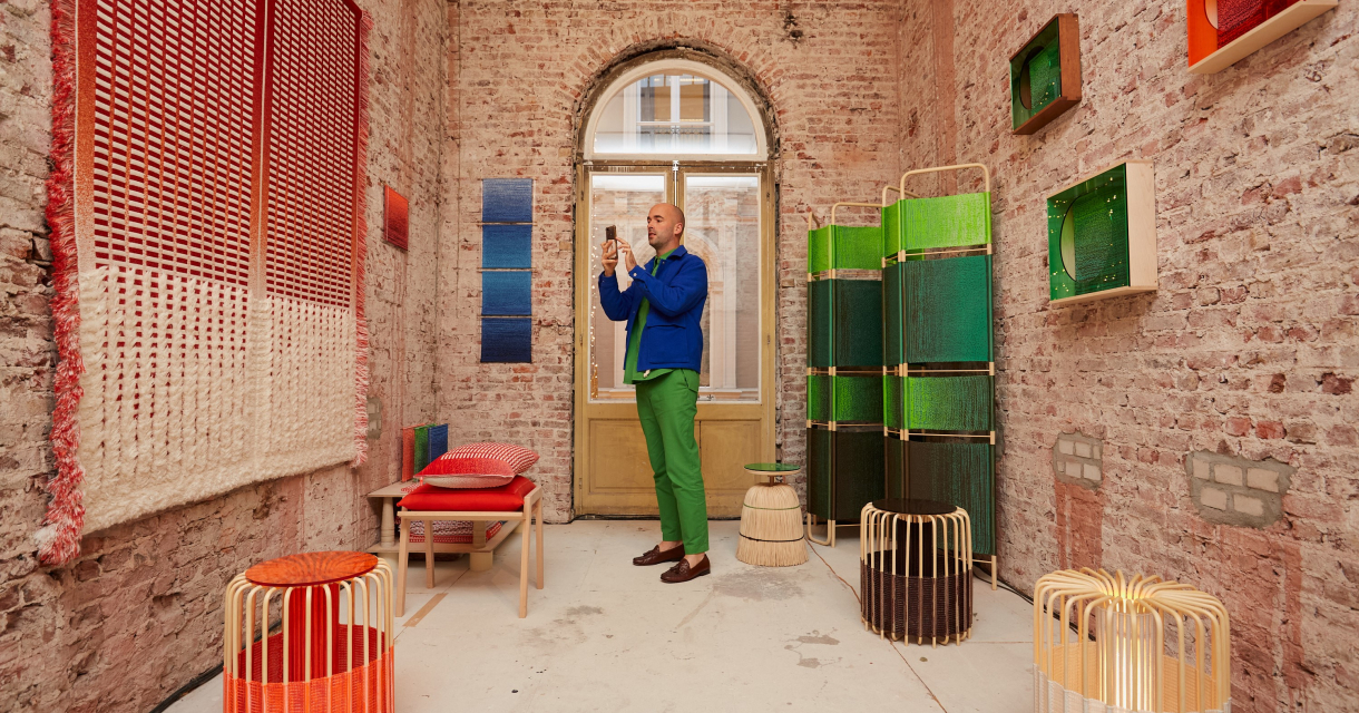 A man photographs art in a colorful room. A man photographs art in a colorful room.