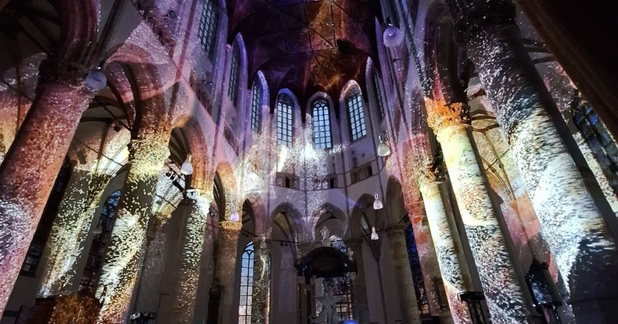 Colorful light projections on the walls of a church.