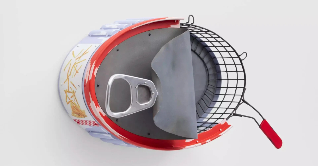 An overhead view of a toy fried food machine with a lid and a removable basket.