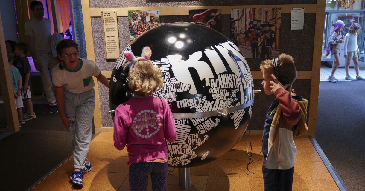 Children listening to music from the globe