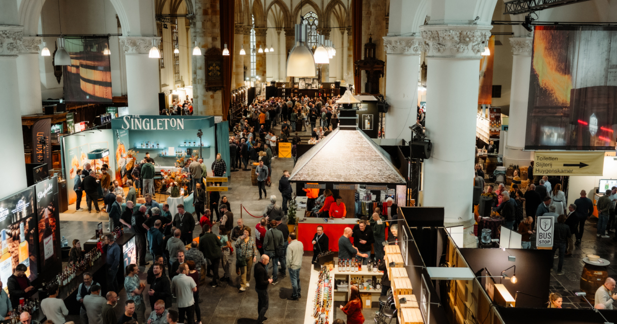 Beverage festival with crowd and booths in a large hall