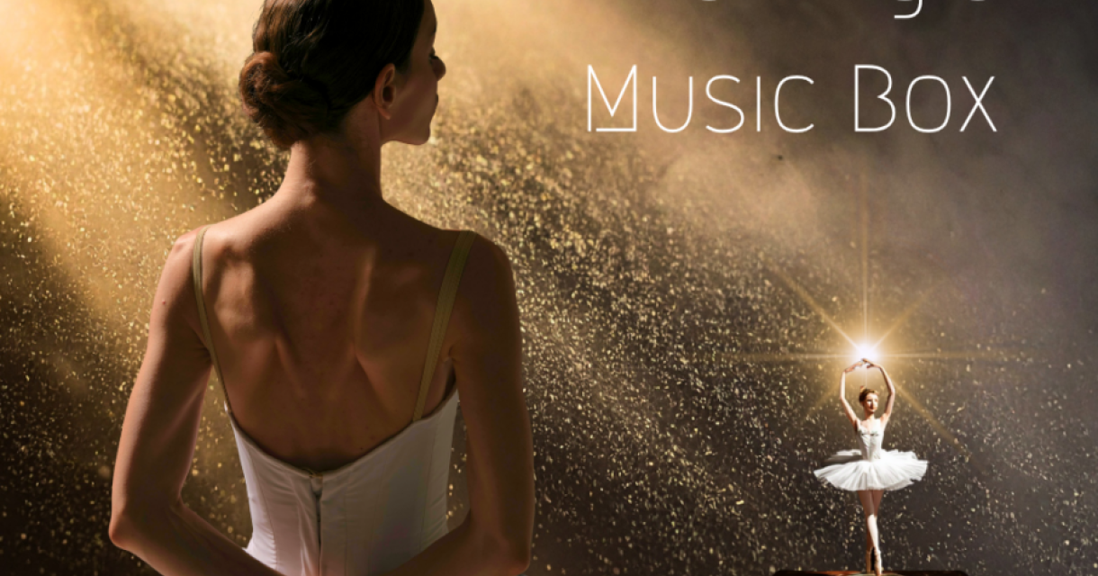 Een ballerina in een witte tutu met een muziekdoos op de achtergrond.