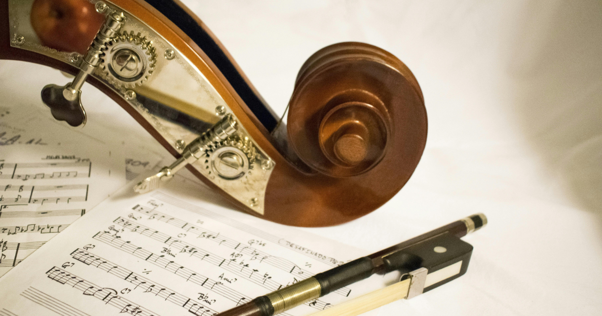 Detail of a musical instrument with sheet music and a pen.
