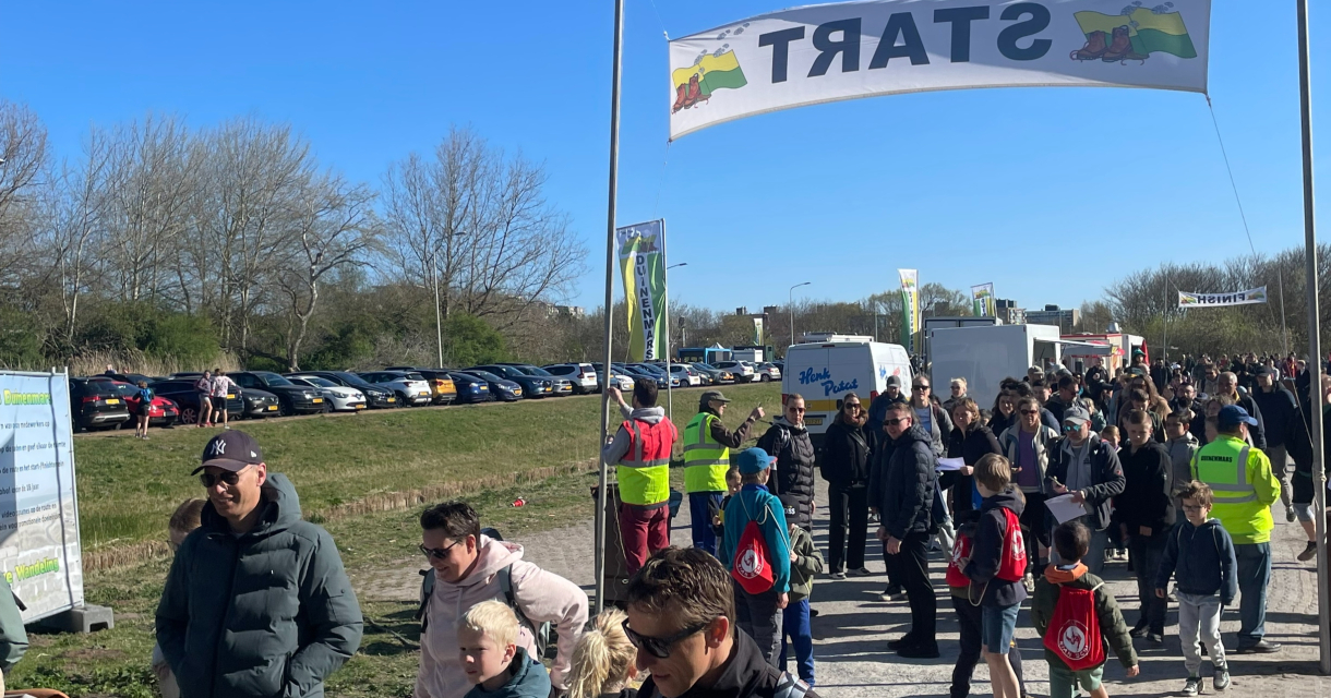 People waiting in line for the start of an event.