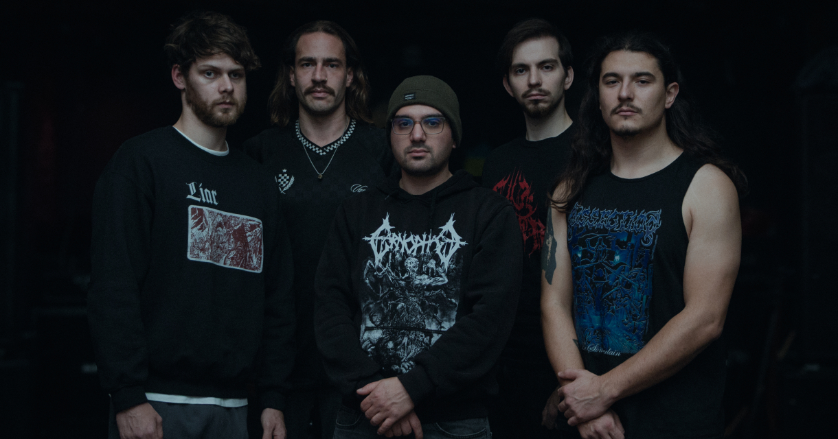 Live performance of a heavy metal band on a small stage with audience in front