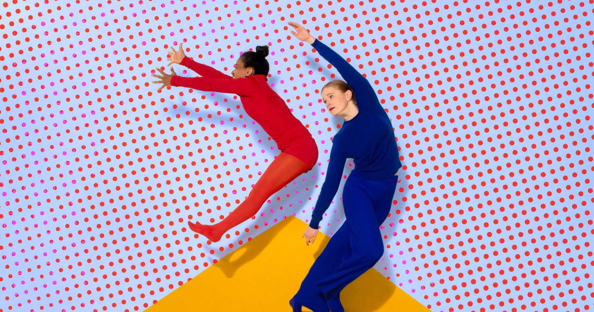 Twee dansers in rode en blauwe outfit springen voor een wand met rode stippen en een gele driehoek op de vloer Twee dansers in rode en blauwe outfit springen voor een wand met rode stippen en een gele driehoek op de vloer