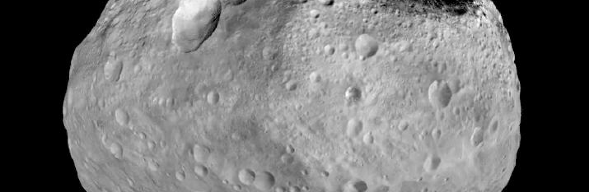 An asteroid with a rough, irregular surface and many craters.
