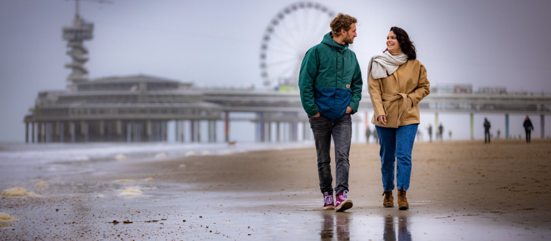 Couple walking on the beach of Scheveningen Couple walking on the beach of Scheveningen