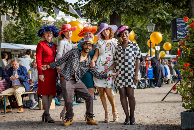 Groep mensen in kleurrijke outfits en hoeden ©Jelle Mes