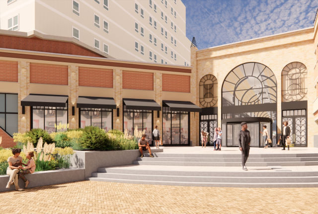 Mensen genieten van een nieuwe winkelplek Palace Promenade Scheveningen met planten en terrassen.